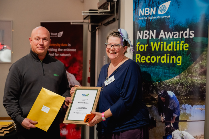 Elizabeth Beston accepting her NBN Newcomer Winner's Award 2025 from Rob Laughton, Opticron